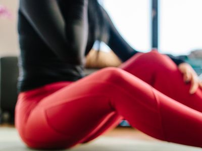 Close-up of a yoga mat rolled out on a wooden floor.